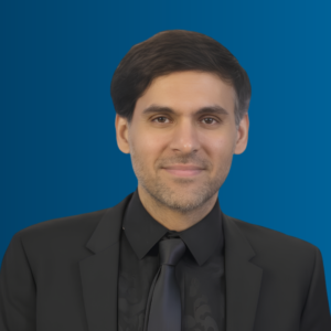 Image of Munir Moosa, a male wearing a black suit and tie.